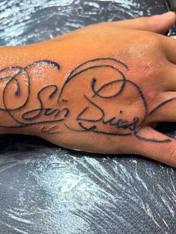 Elegant script lettering on a hand