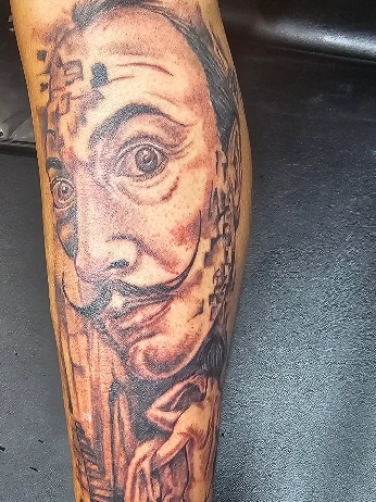 Black-and-grey portrait tattoo