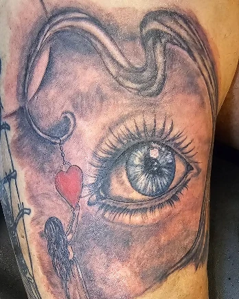 Black-and-grey surreal eye tattoo